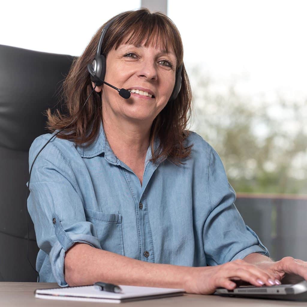 Female operator taking a call with a headset.